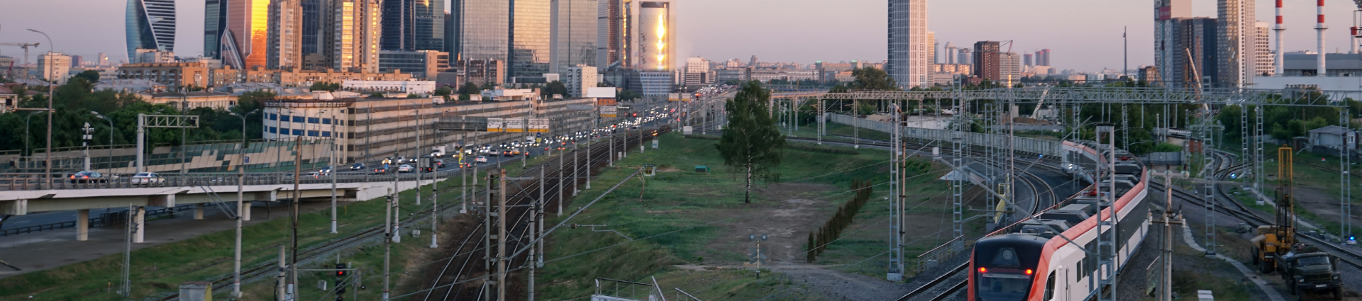 Panoramic view of a road and rail network with a modern city in the distance